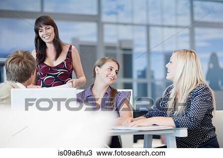 Business people talking at desk View Large Photo Image Stock Image - Business people talking at desk. Fotosearch