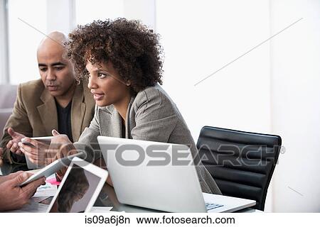 Picture - Business people talking in meeting. Fotosearch