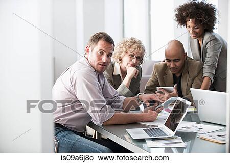 Picture - Business people talking in meeting. Fotosearch