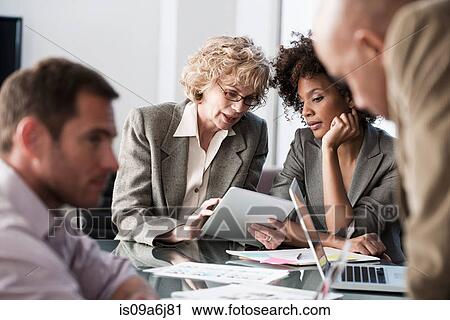 Stock Image - Business people talking in meeting. Fotosearch