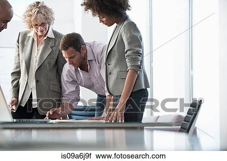Stock Image - Business people talking in meeting. Fotosearch