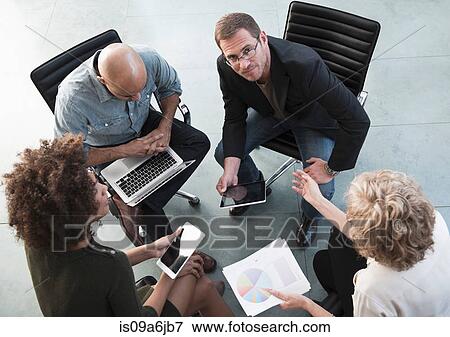 Stock Photo - Business people talking in office. Fotosearch