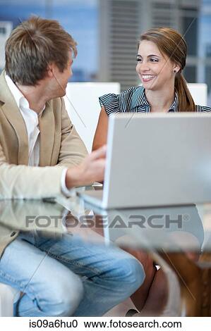 Stock Image - Business people working on laptop. Fotosearch