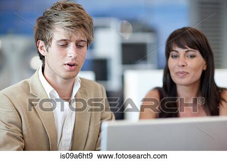 Stock Photo - Business people working on laptop. Fotosearch