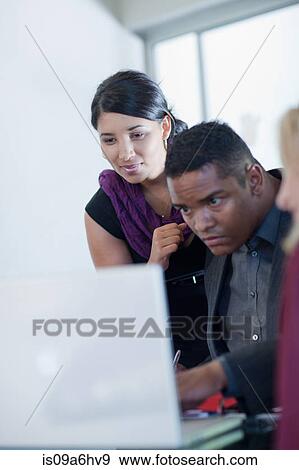 Stock Photo - Business people working on laptop. Fotosearch