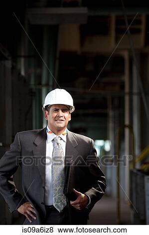 Stock Photo - Businessman carrying folder in plant. Fotosearch