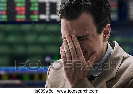 Stock Image - Businessman crying at stock exchange. Fotosearch