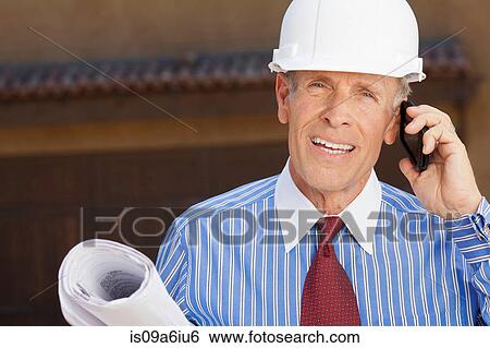 Businessman in hard hat with blueprints View Large Photo Image Stock Photograph - Businessman in hard hat with blueprints. Fotosearch