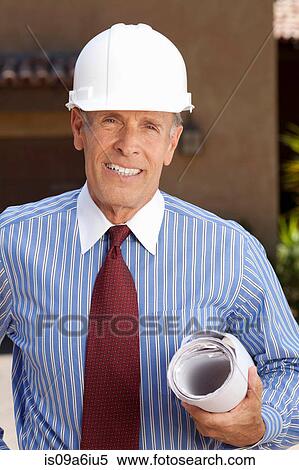 Businessman in hard hat with blueprints View Large Photo Image Stock Photography - Businessman in hard hat with blueprints. Fotosearch