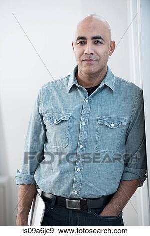 Stock Photo - Businessman standing in office. Fotosearch