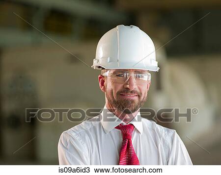 Stock Image - Businessman standing on site. Fotosearch