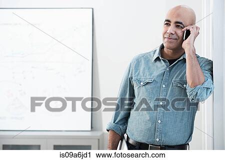 Businessman talking on cell phone View Large Photo Image Stock Image - Businessman talking on cell phone. Fotosearch