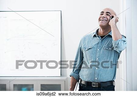 Stock Image - Businessman talking on cell phone. Fotosearch