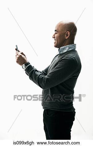 Stock Image - Businessman texting on smartphone. Fotosearch