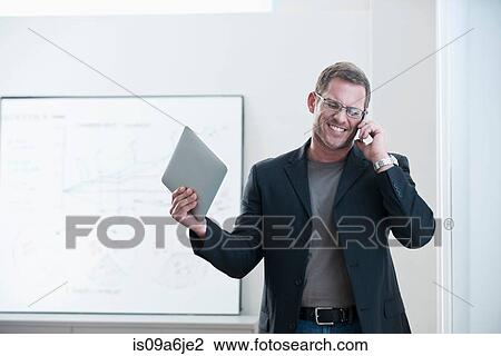 Stock Image - Businessman using tablet computer. Fotosearch