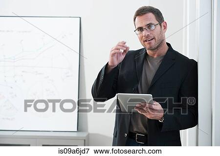 Businessman using tablet computer View Large Photo Image Stock Photo - Businessman using tablet computer. Fotosearch