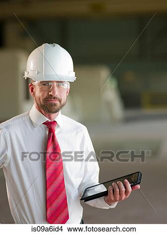 Businessman with tablet computer on site View Large Photo Image Picture - Businessman with tablet computer on site. Fotosearch