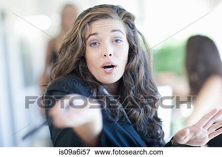 Businesswoman gesturing at desk View Large Photo Image Stock Photo - Businesswoman gesturing at desk. Fotosearch