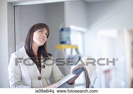 Stock Photography - Businesswoman looking at fabric swatches. Fotosearch