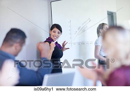 Stock Image - Businesswoman making graph on glass. Fotosearch