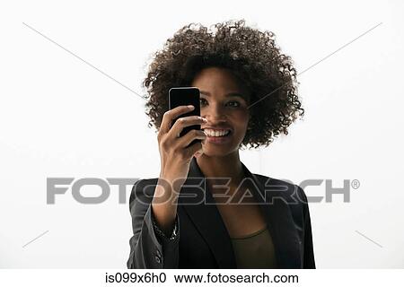 Businesswoman photographing self on cameraphone View Large Photo Image Stock Image - Businesswoman photographing self on cameraphone. Fotosearch