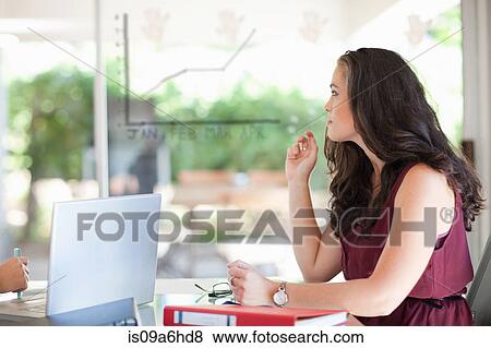Stock Photo - Businesswoman sitting in meeting. Fotosearch