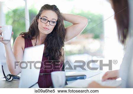Stock Photography - Businesswoman sitting in meeting. Fotosearch