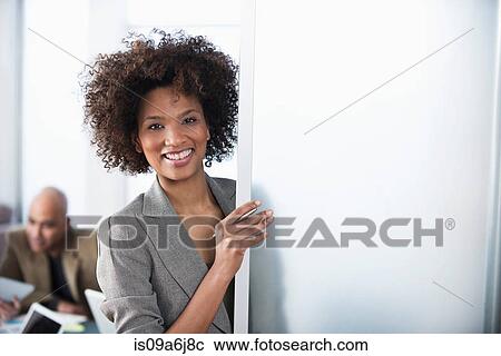 Businesswoman smiling in office doorway View Large Photo Image Stock Image - Businesswoman smiling in office doorway. Fotosearch