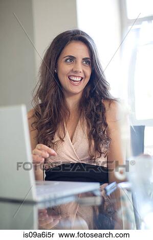 Businesswoman talking at desk View Large Photo Image Stock Photography - Businesswoman talking at desk. Fotosearch