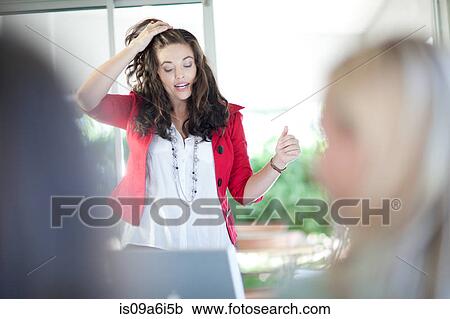 Stock Image - Businesswoman talking in meeting. Fotosearch