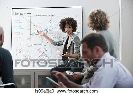 Stock Image - Businesswoman talking in meeting. Fotosearch