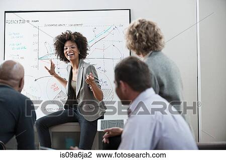 Stock Image - Businesswoman talking in meeting. Fotosearch