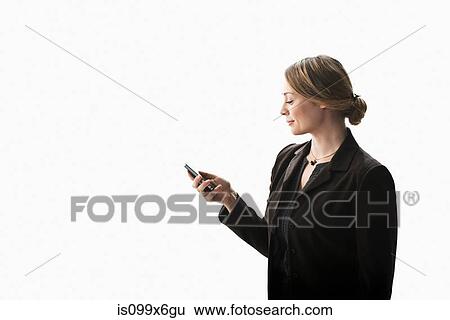 Businesswoman texting on smartphone View Large Photo Image Stock Photograph - Businesswoman texting on smartphone. Fotosearch
