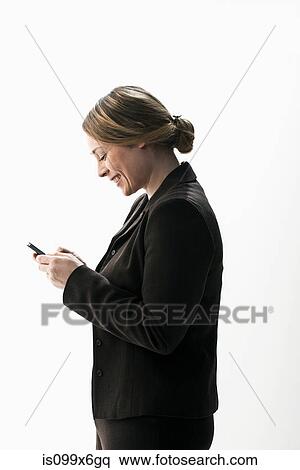 Businesswoman texting on smartphone View Large Photo Image Stock Photography - Businesswoman texting on smartphone. Fotosearch