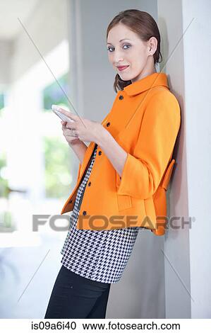 Businesswoman using cell phone in office View Large Photo Image Stock Image - Businesswoman using cell phone in office. Fotosearch