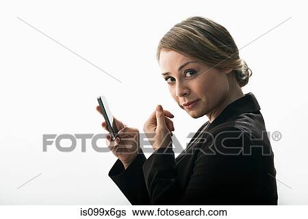 Businesswoman using smartphone as mirror View Large Photo Image Stock Photograph - Businesswoman using smartphone as mirror. Fotosearch