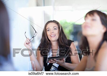 Businesswoman with tablet computer in meeting View Large Photo Image Stock Photo - Businesswoman with tablet computer in meeting. Fotosearch