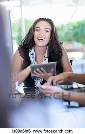 Businesswoman with tablet computer in meeting View Large Photo Image Stock Photograph - Businesswoman with tablet computer in meeting. Fotosearch