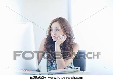 Stock Photo - Businesswoman working on computer. Fotosearch