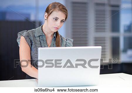 Businesswoman working on laptop View Large Photo Image Picture - Businesswoman working on laptop. Fotosearch