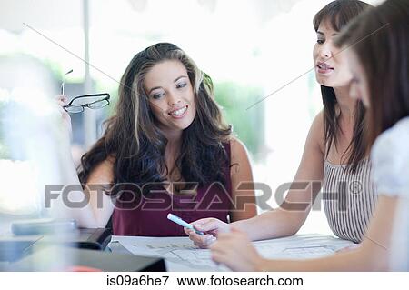Stock Photo - Businesswomen talking in meeting. Fotosearch