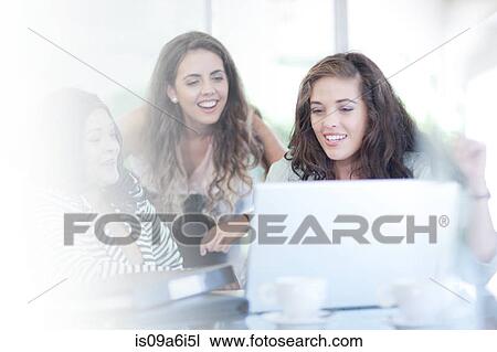 Businesswomen using laptop at desk View Large Photo Image Stock Image - Businesswomen using laptop at desk. Fotosearch