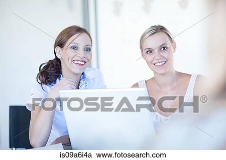 Stock Image - Businesswomen working on laptop. Fotosearch