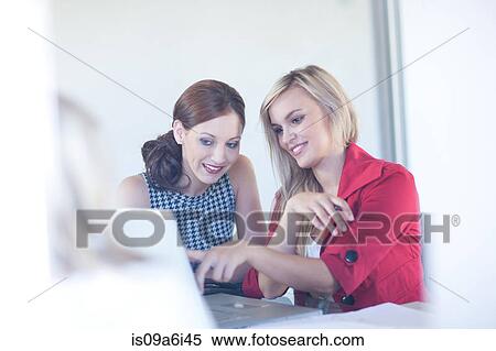 Stock Photography - Businesswomen working on laptop. Fotosearch