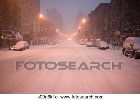 Stock Image - Cars parked on snowy city street. Fotosearch