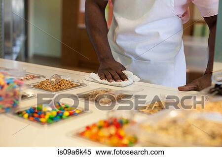 Cashier cleaning counter in store View Large Photo Image Stock Photography - Cashier cleaning counter in store. Fotosearch