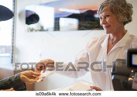 Cashier handing spoon to customer View Large Photo Image Stock Image - Cashier handing spoon to customer. Fotosearch