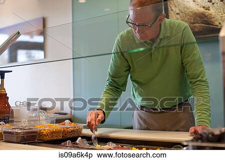 Cashier organizing toppings at counter View Large Photo Image Stock Photography - Cashier organizing toppings at counter. Fotosearch