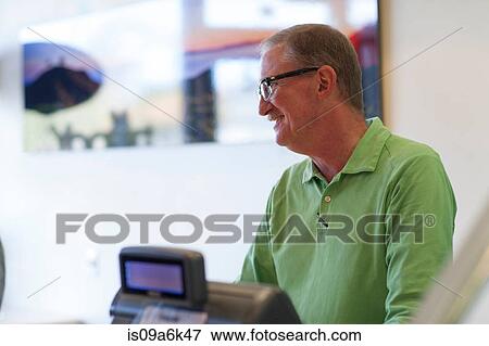 Stock Photo - Cashier talking in store. Fotosearch