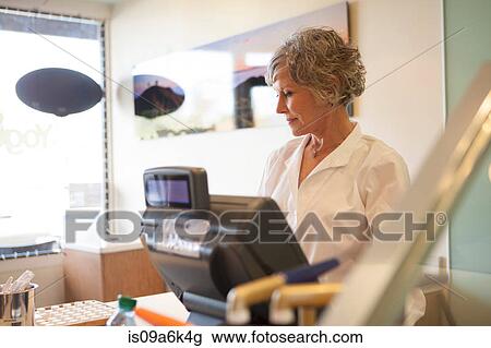 Cashier wearing uniform in store View Large Photo Image Stock Image - Cashier wearing uniform in store. Fotosearch